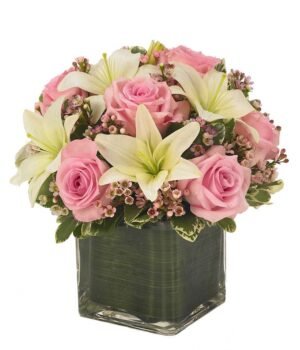 Cube vase arrangement of white lilies, pink roses and pink berries