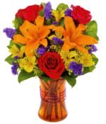 Bi-color roses, orange lilies, purple statice, solidago in a purple glass vase