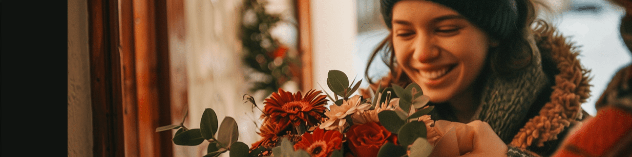 happy friend receiving flowers at door from Local Florist